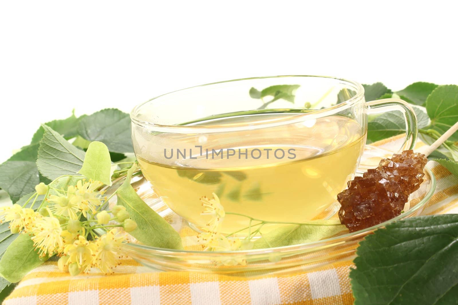 hot fresh lime blossom tea with flowers and leaves on a bright background