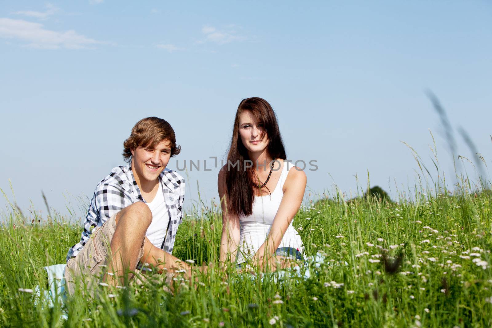 young couple outdoor in summer on blanket in love