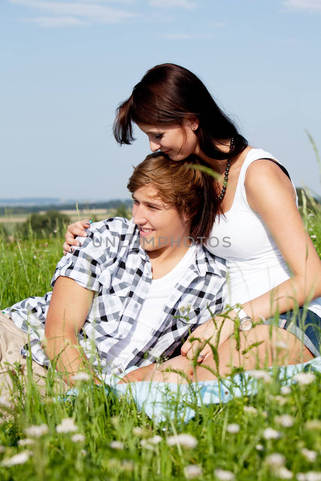 young couple outdoor in summer on blanket in love