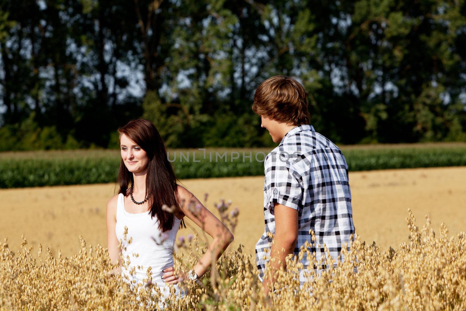 happy couple in love outdoor in summer on field having fun