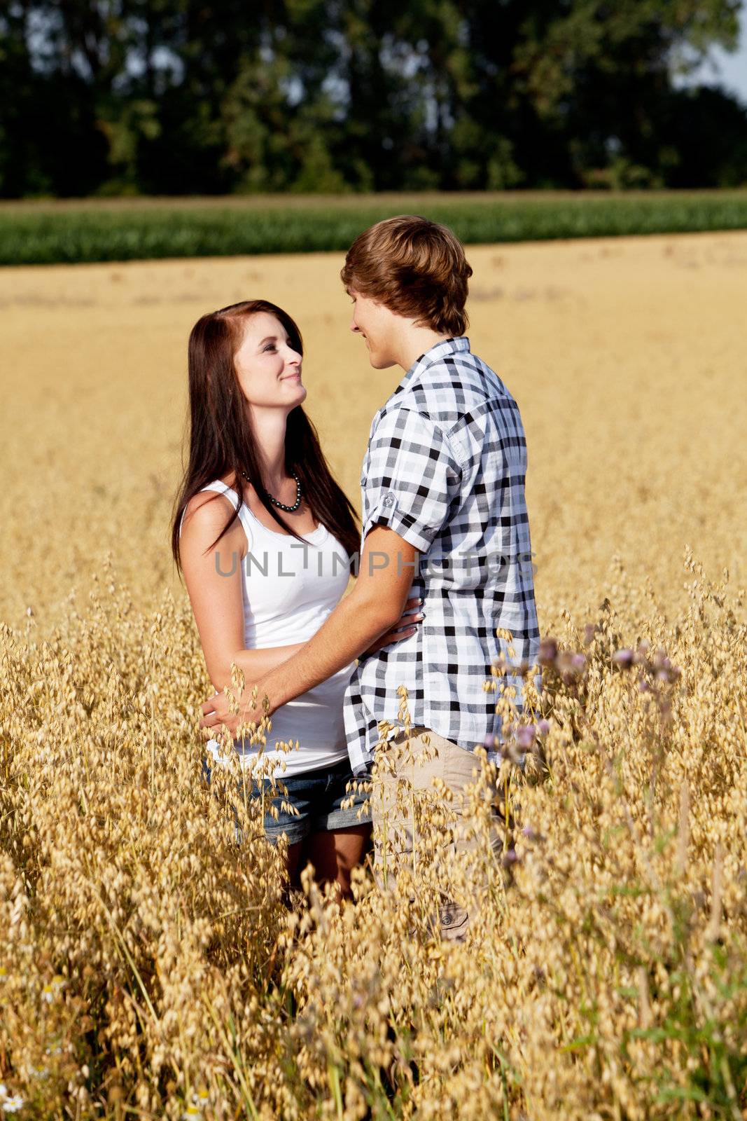 happy couple in love outdoor in summer on field having fun