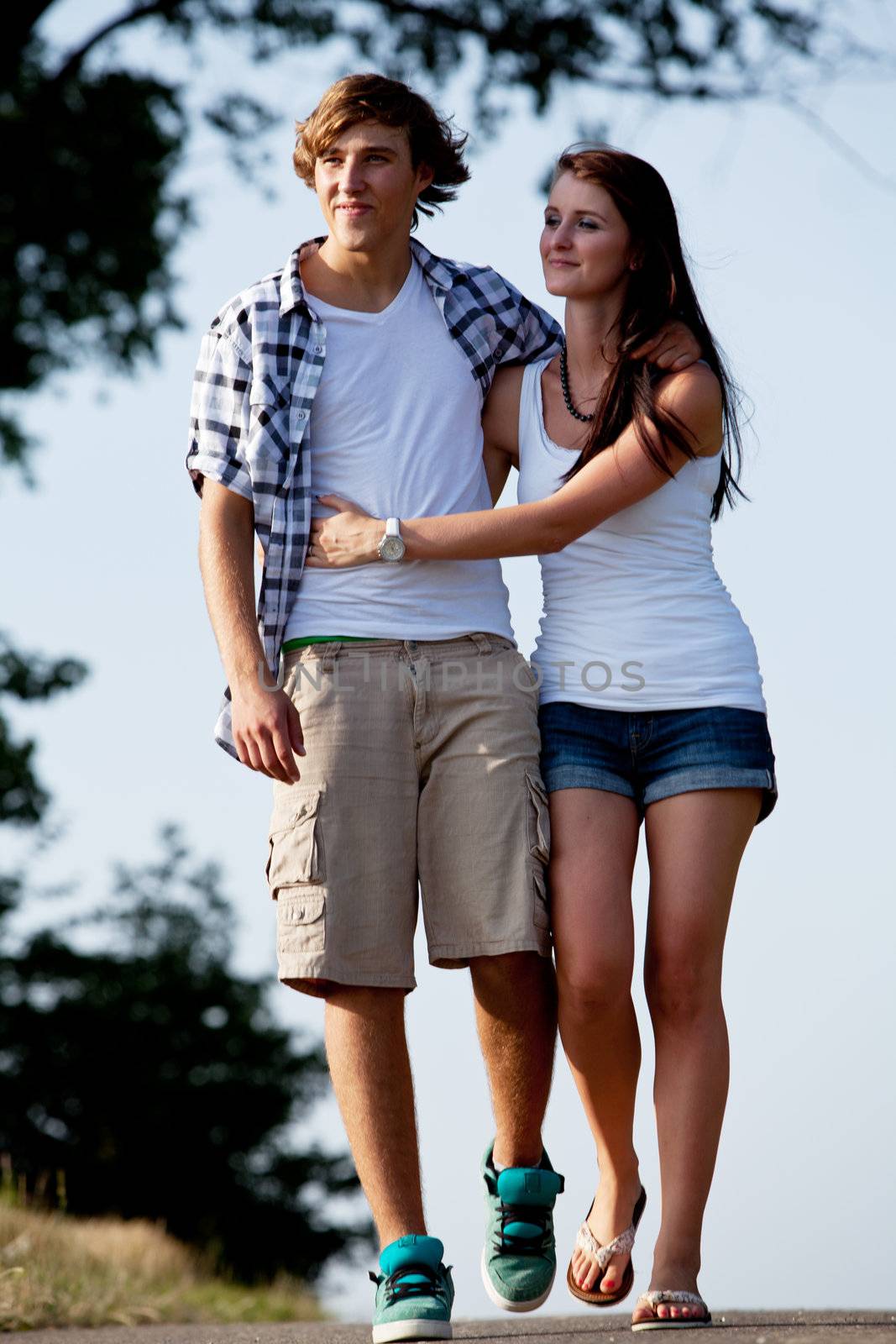 young woman and man is walking on  a road in summer outdoor happy
