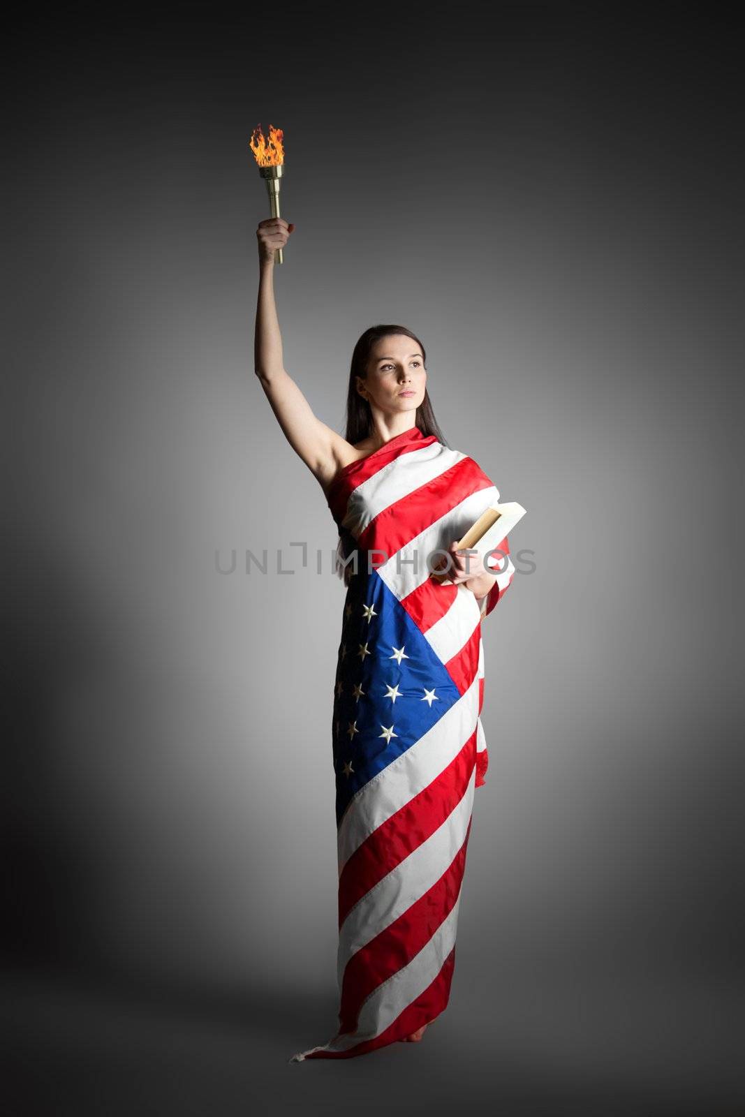 woman in the American flag in the style of the statue of liberty