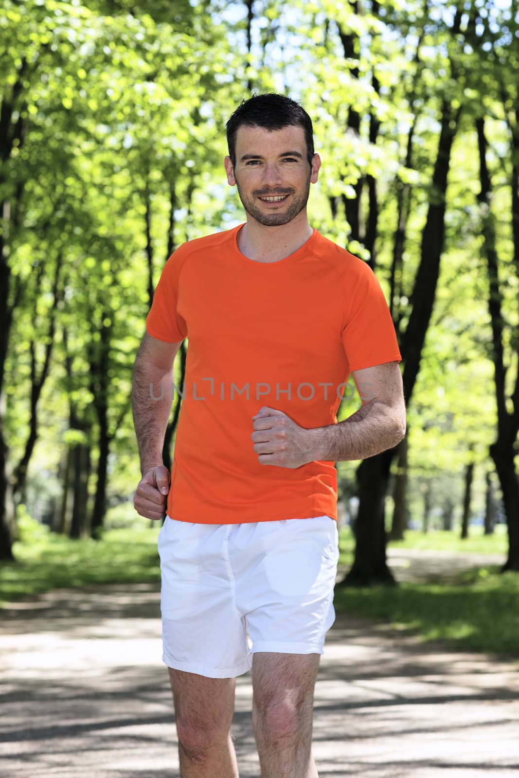 man running in a park in summer