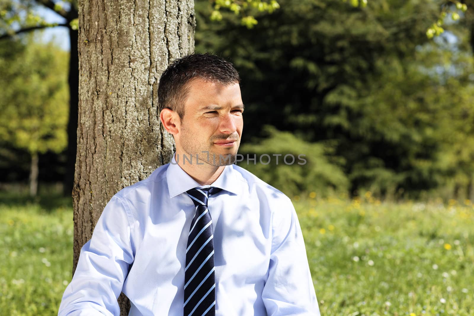 young businessman alone in nature in summer