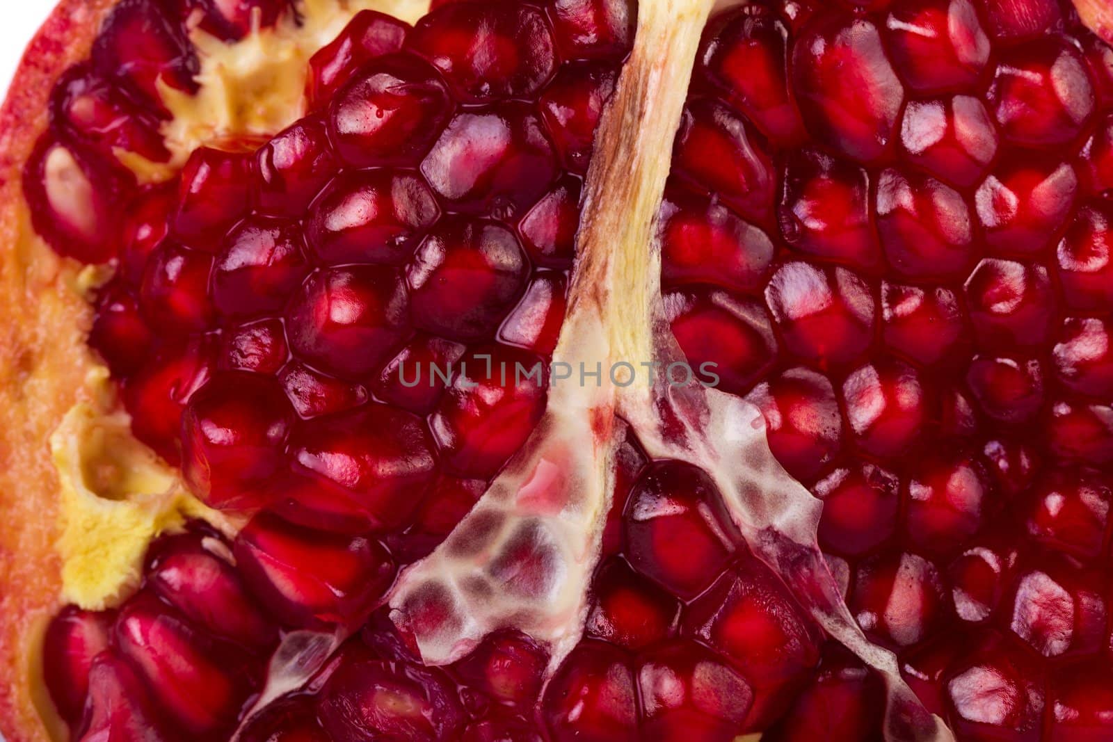 Close up view of some pomegranate fruit  isolated on a white background.