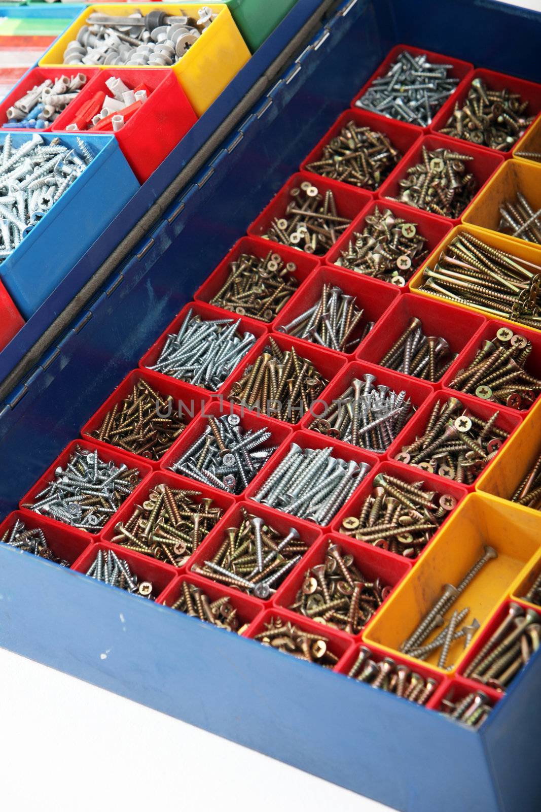 Large toolbox with segregated new metal long bolts and screws of different sizes and types