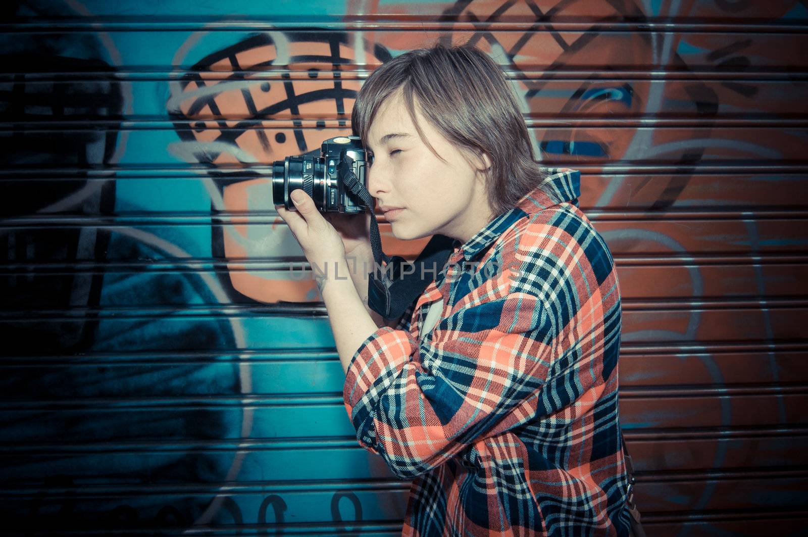 hipster young woman taking photo in the street