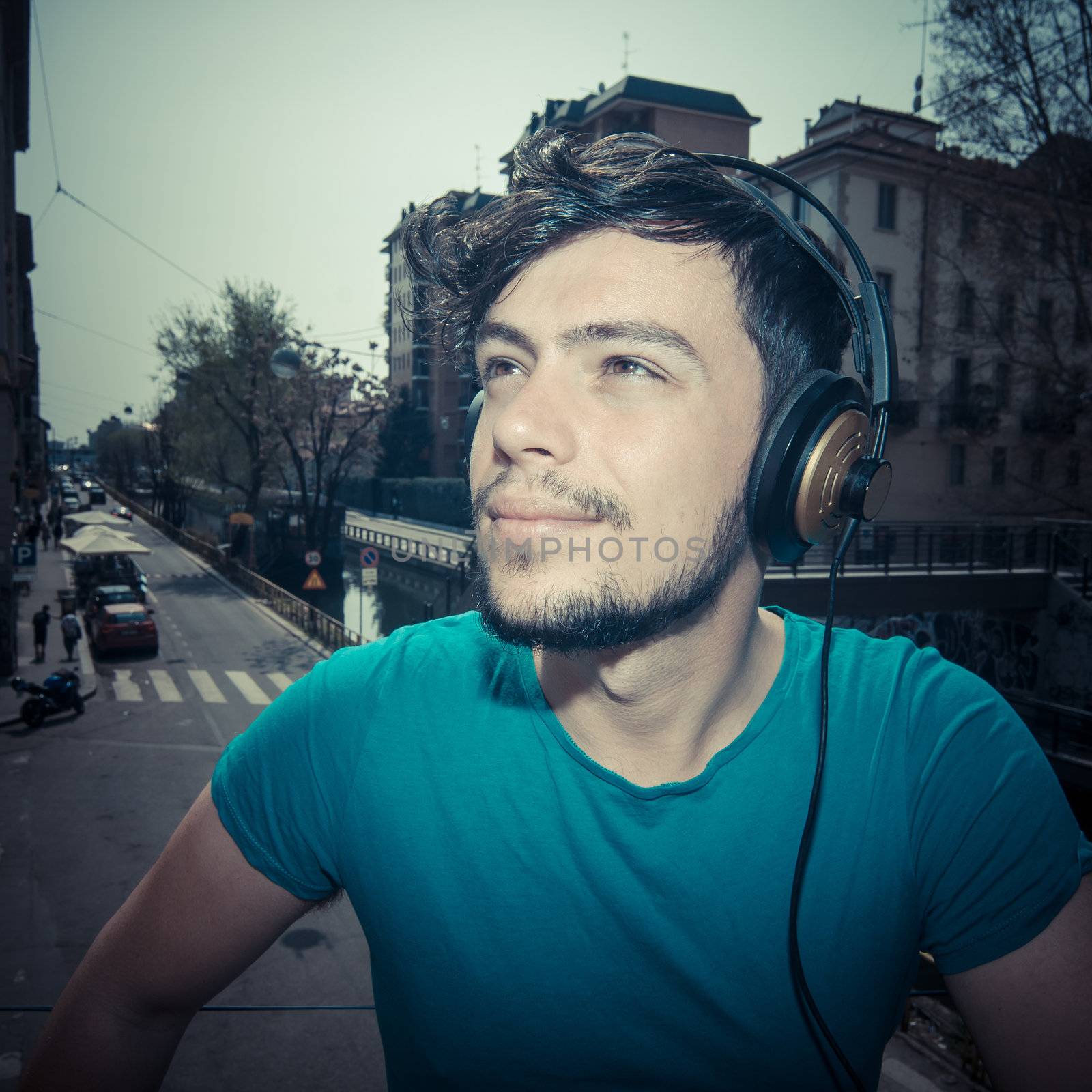 young man hipster listening to music with headphones
