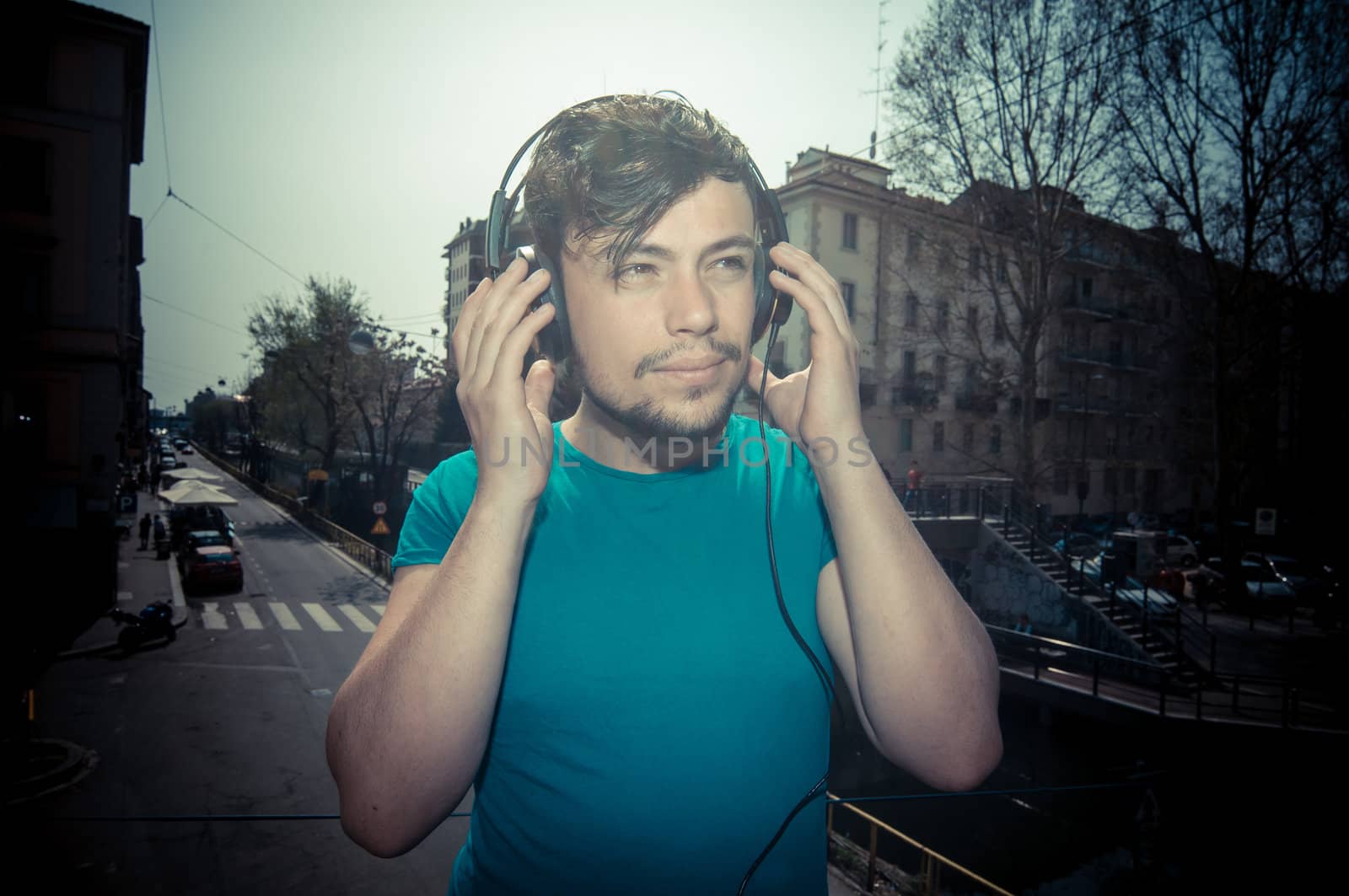 young man hipster listening to music with headphones