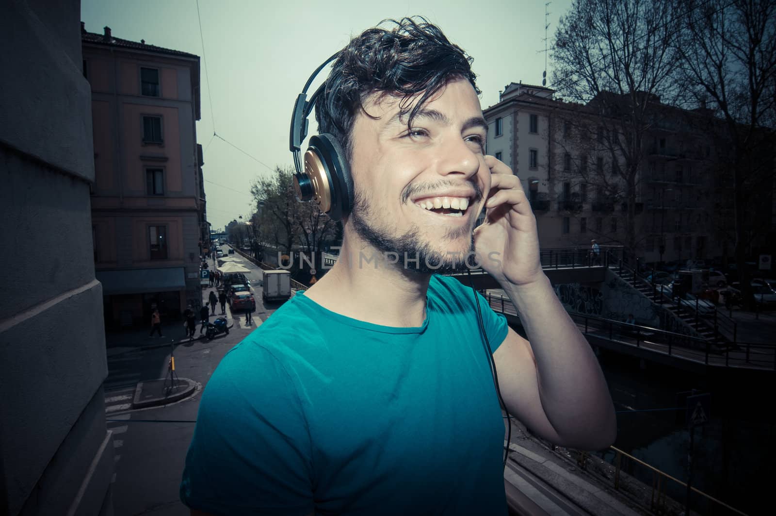 young man hipster listening to music with headphones