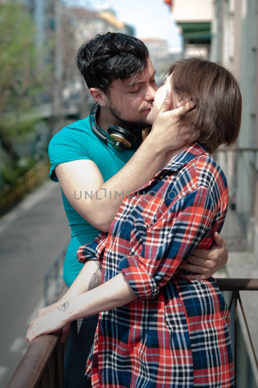 young couple kissing in the street