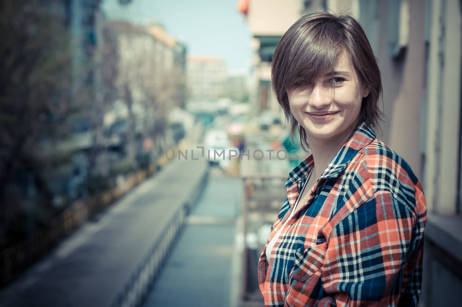 hipster girl on balcony smiling