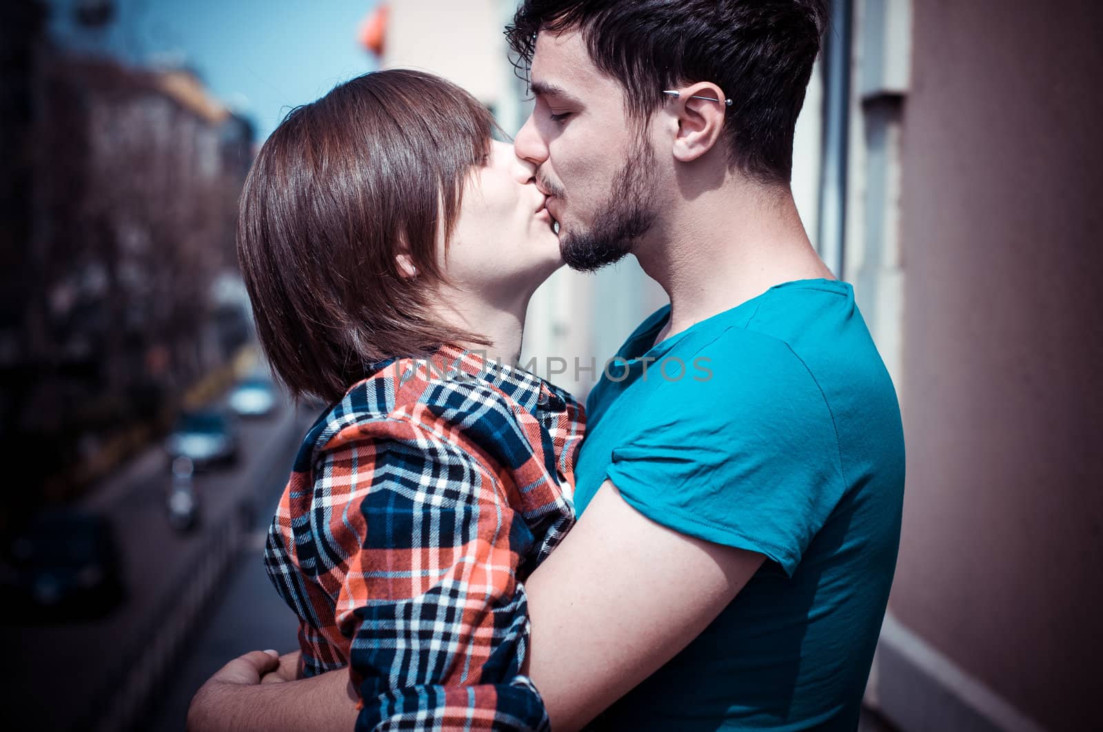 young couple kissing by peus
