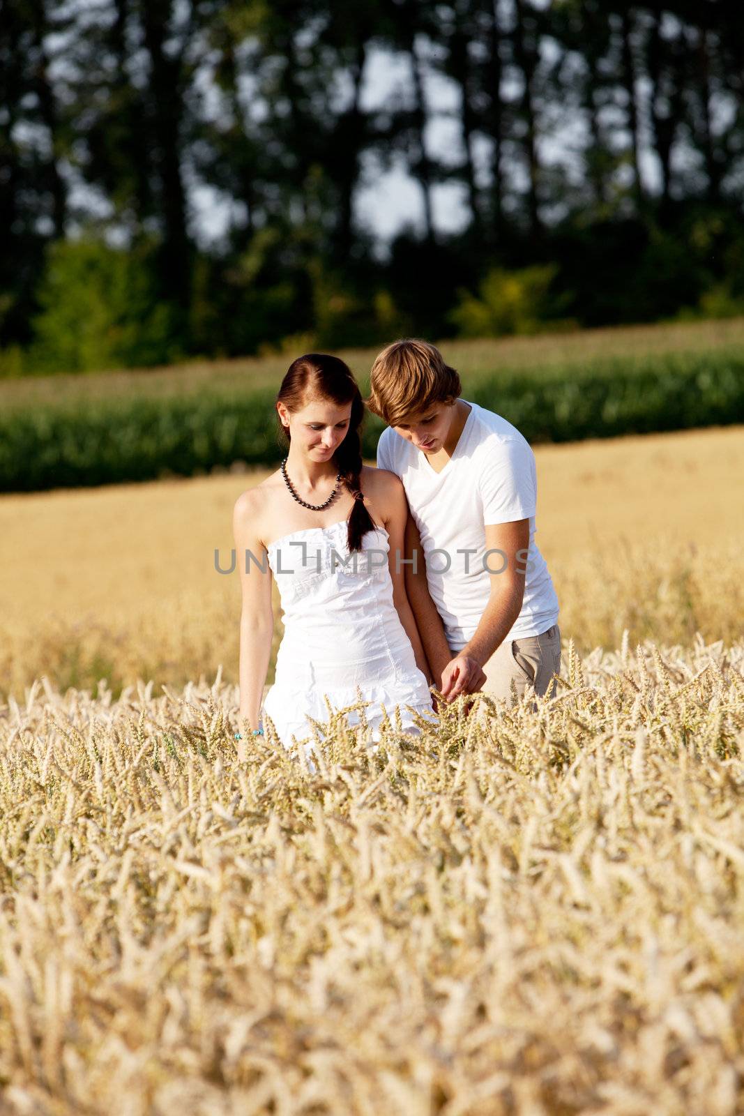 happy couple in love outdoor in summer on field having fun