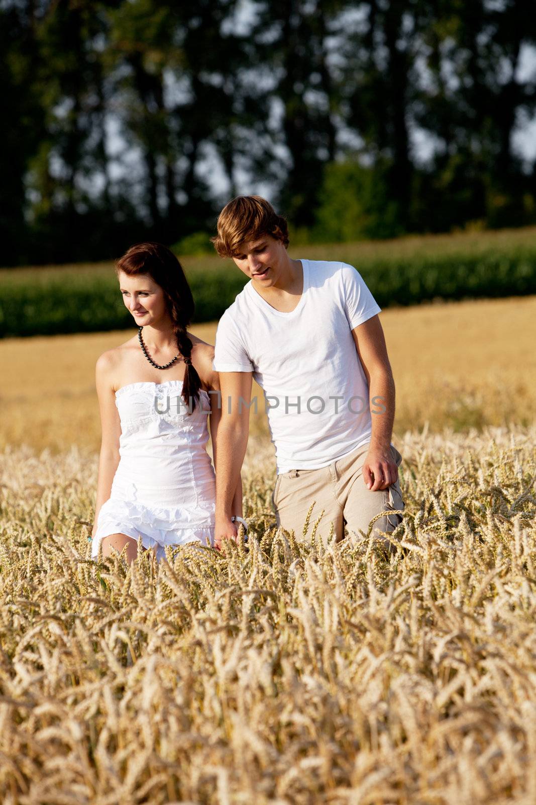 happy couple in love outdoor in summer on field having fun