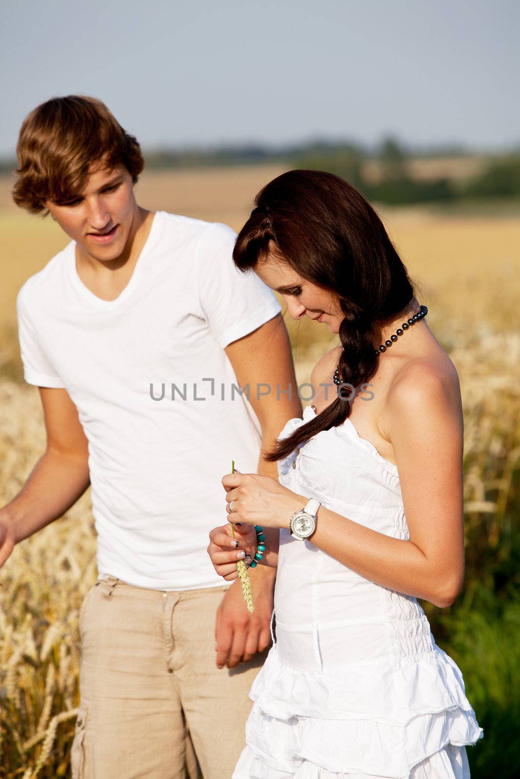 happy couple in love outdoor in summer on field having fun