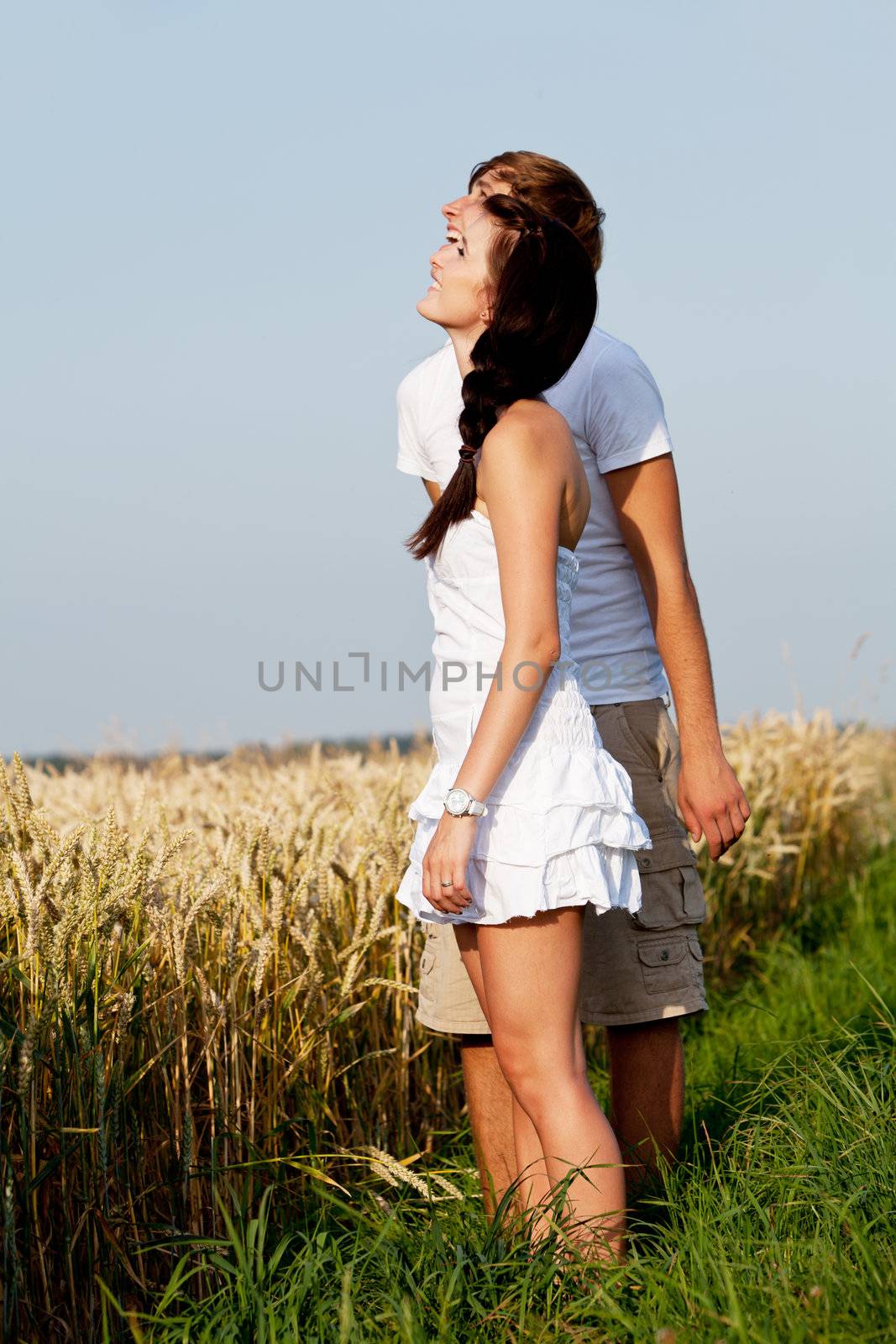 happy couple in love outdoor in summer on field having fun