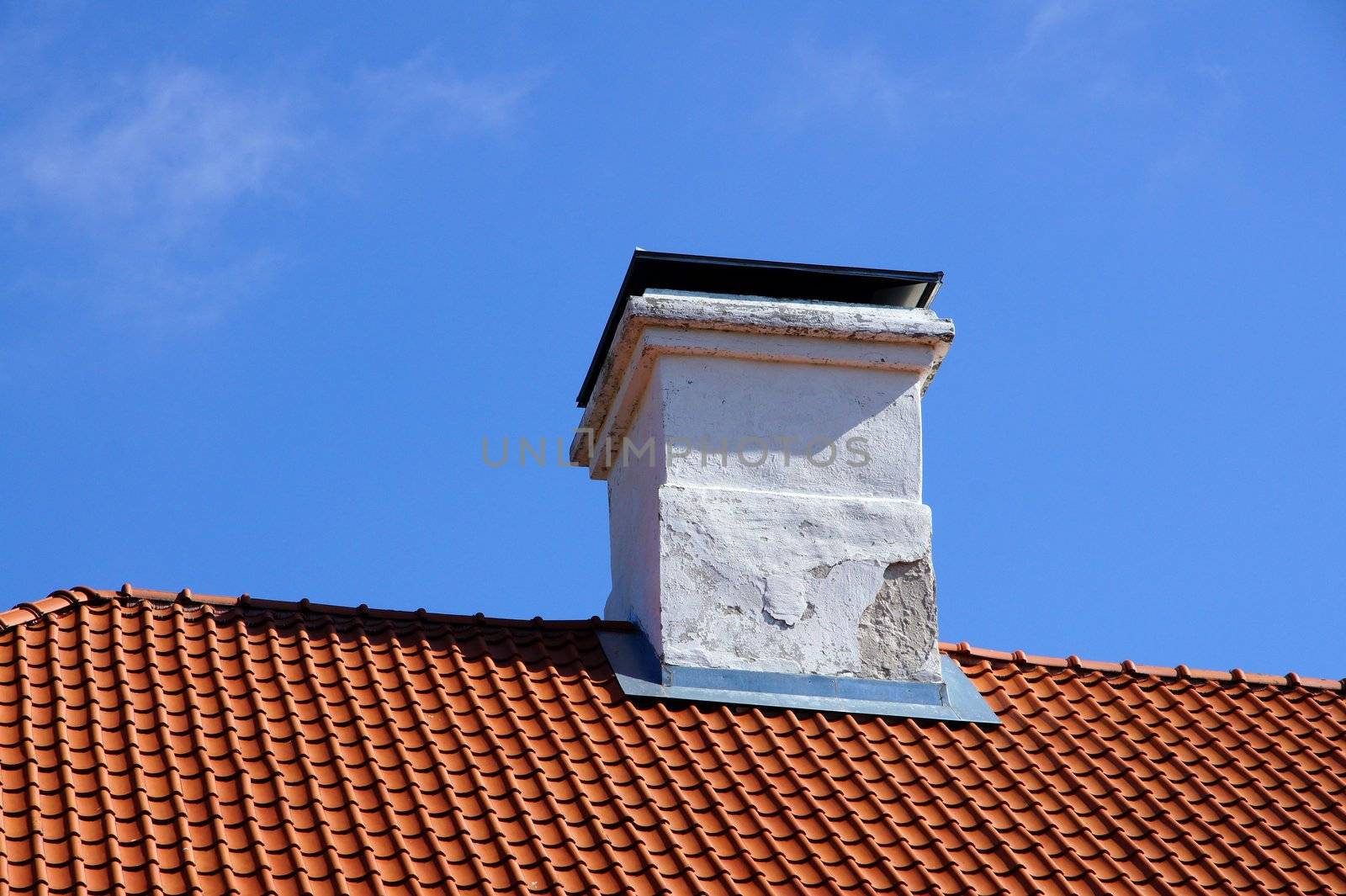 The roof and chimney with blue sky