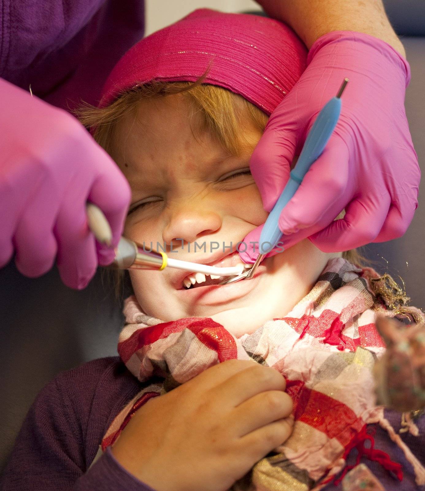 Little girl getting her teeth checked at the dentist