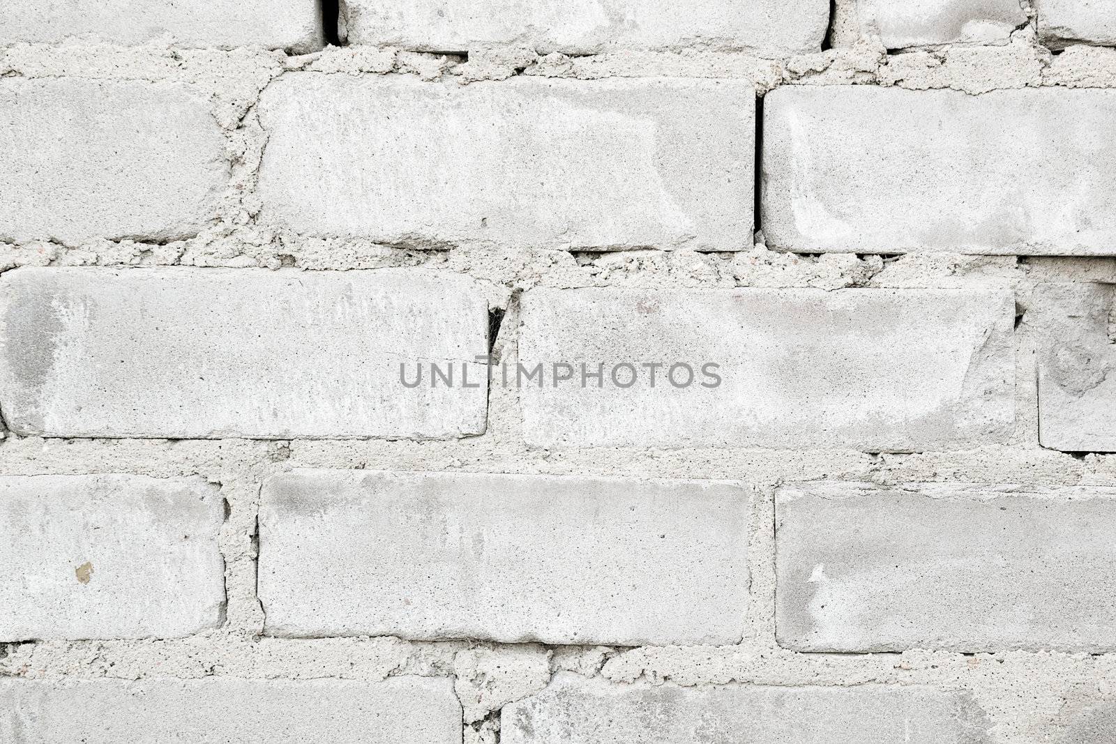 rough rough wall of gray brick with cement