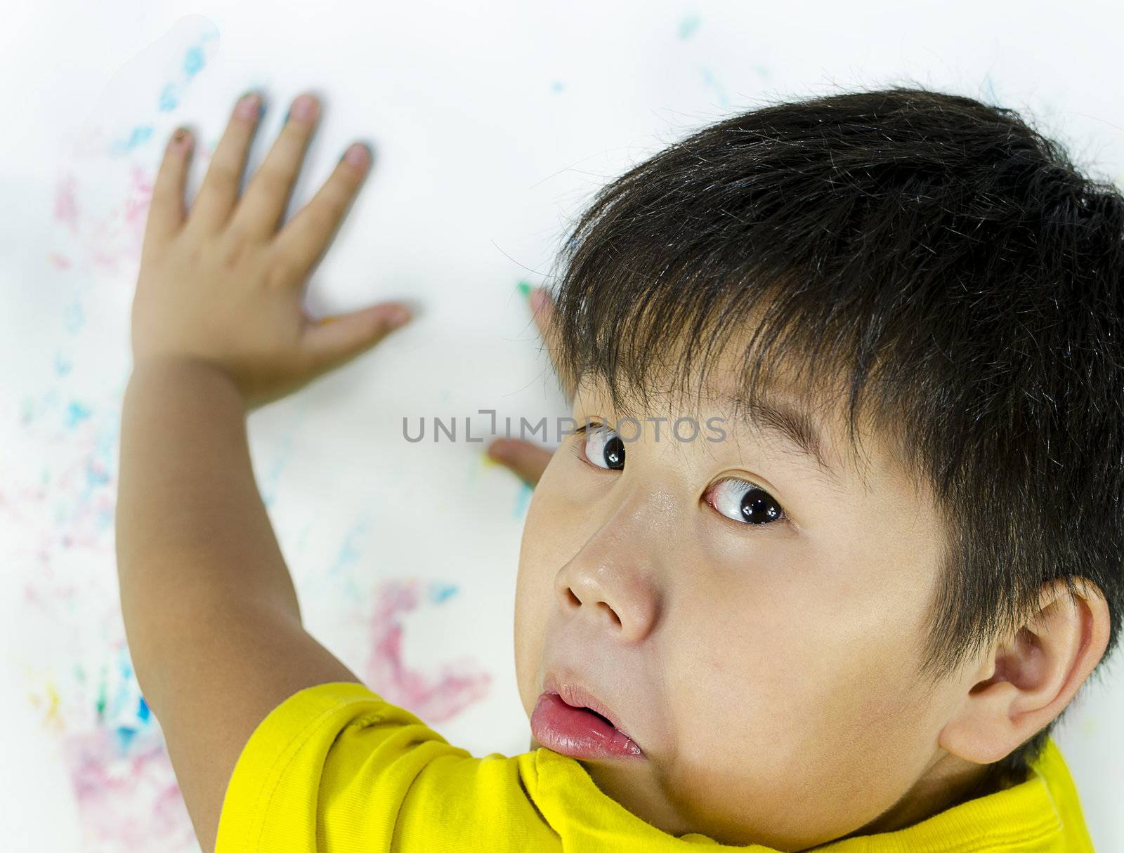 a child being caught while painting on the wall