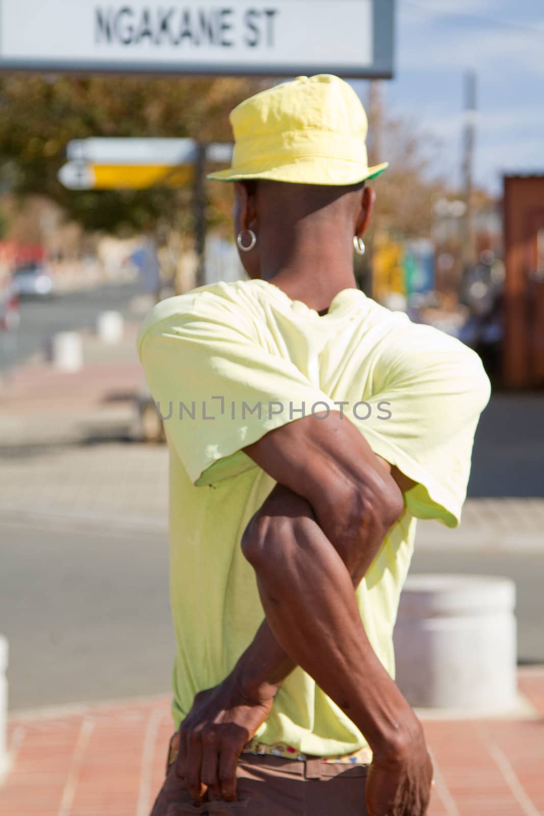 Soweto, South Africa– July 29 – A street performer demonstrates several acrobatic moves showing his body’s unbelievable flexibility near  Mandela’s house on July 29, 2012 in Soweto, South Africa