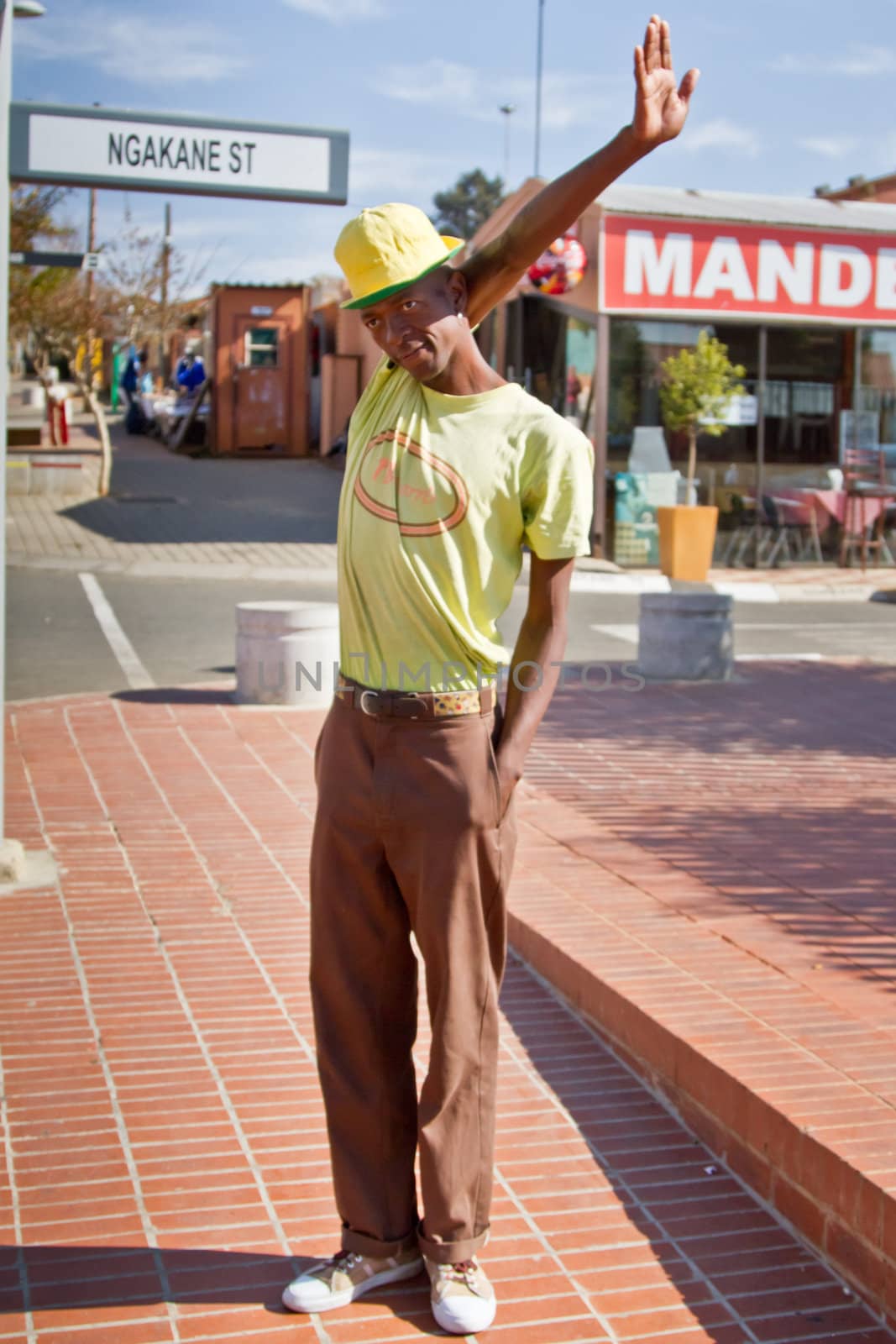 Soweto, South Africa– July 29 – A street performer demonstrates several acrobatic moves showing his body’s unbelievable flexibility near  Mandela’s house on July 29, 2012 in Soweto, South Africa