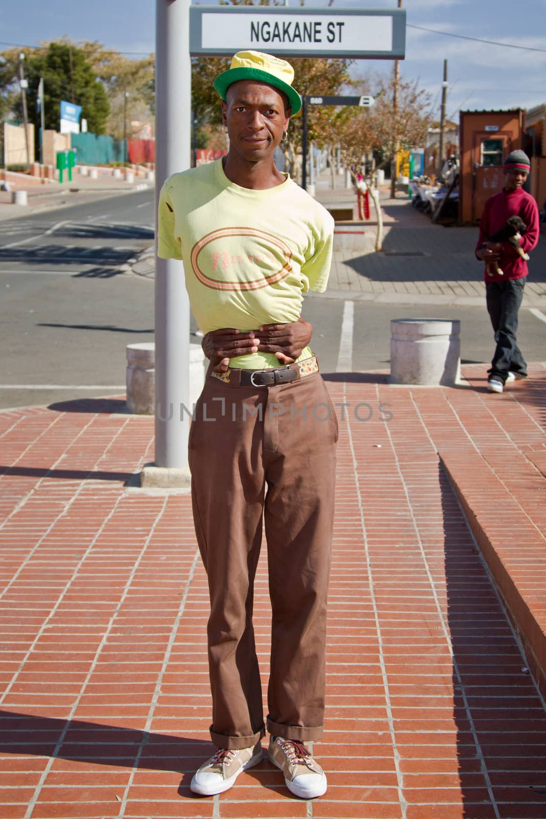 Soweto, South Africa– July 29 – A street performer demonstrates several acrobatic moves showing his body’s unbelievable flexibility near  Mandela’s house on July 29, 2012 in Soweto, South Africa