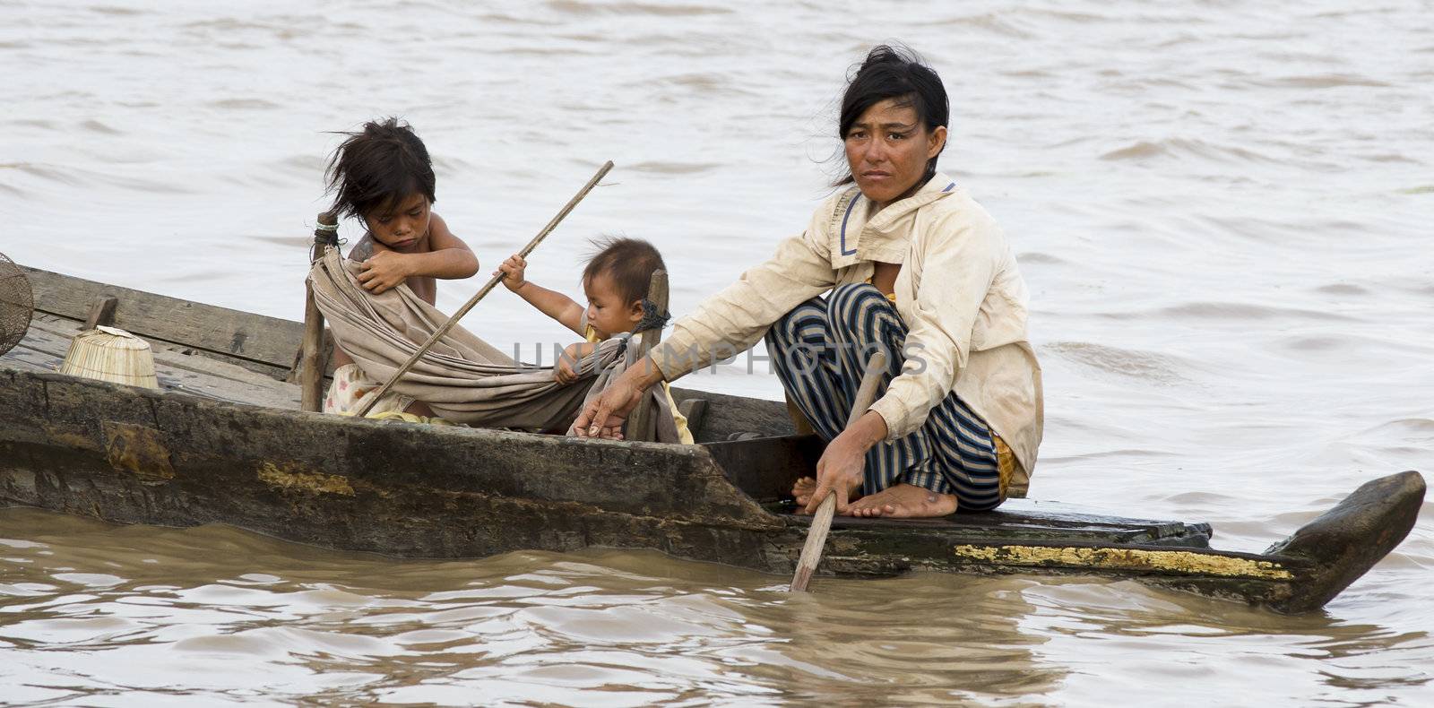 Sien reap Cambodia 2012- floating village family on a boat.