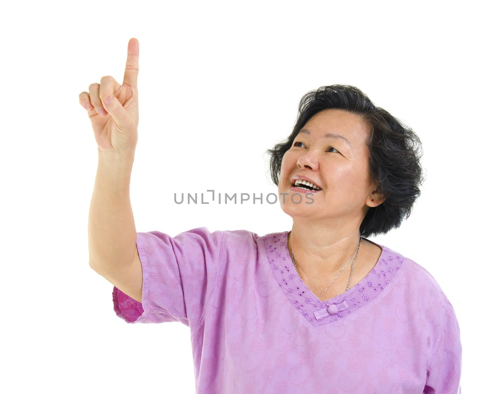 60s Asian senior woman pointing on transparent virtual screen button, over white background