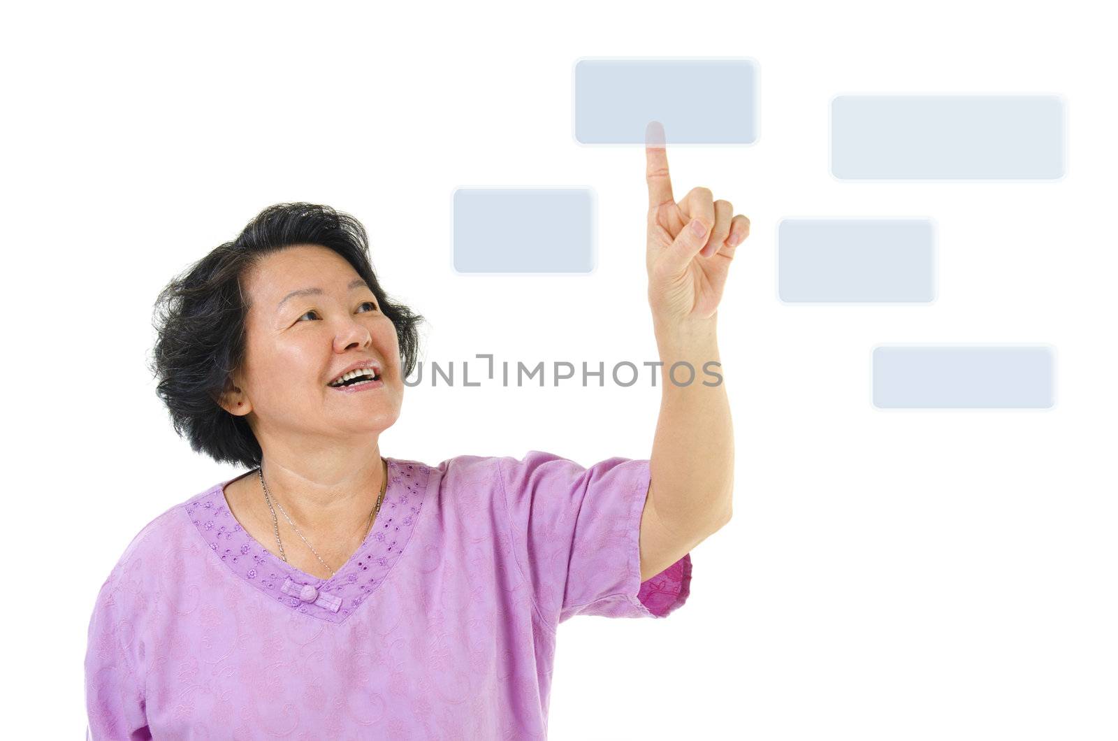 60s Asian senior woman pointing on transparent virtual screen, space for text/button