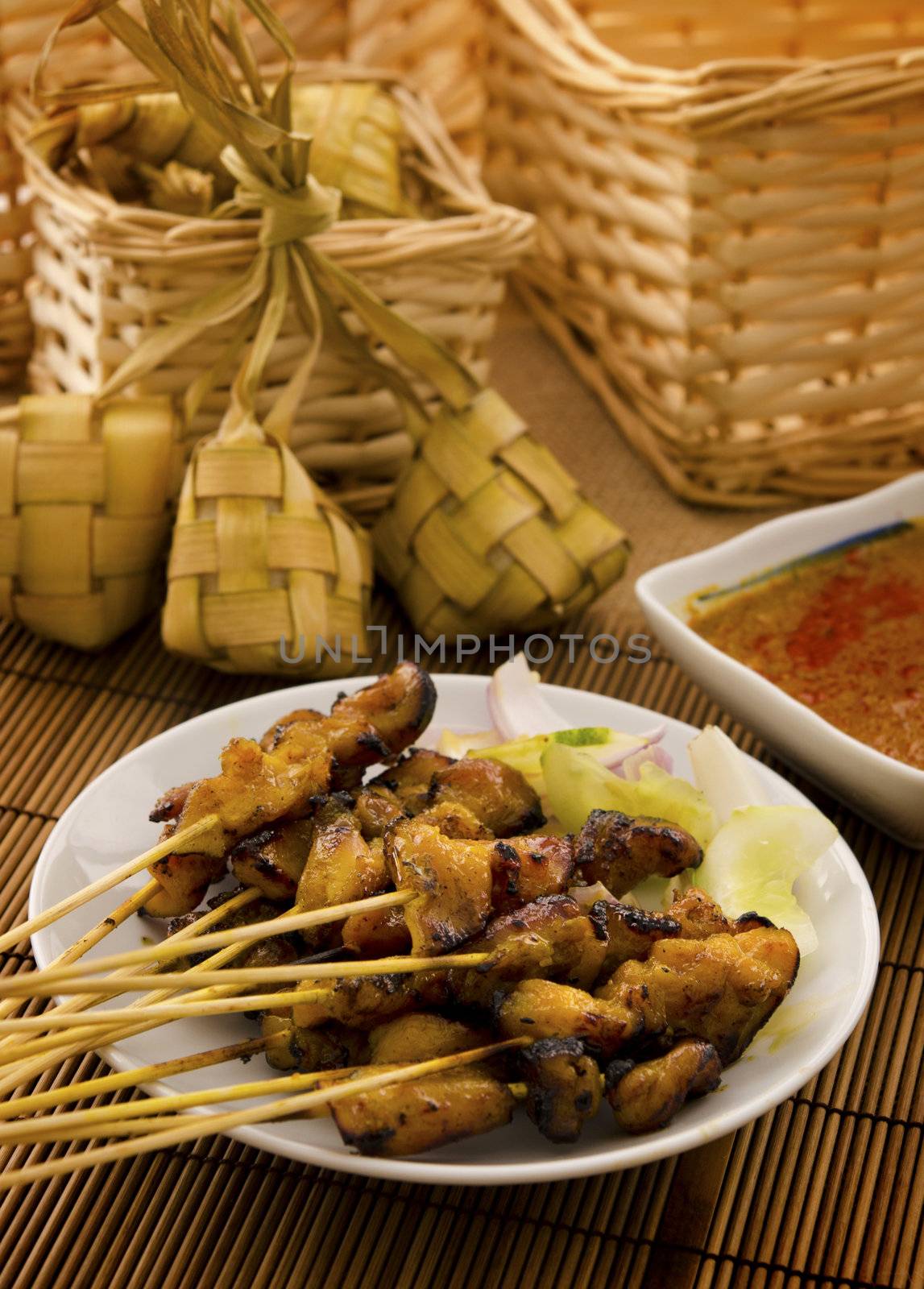 Asian Malay Ramadan food, satay chicken and ketupat in low light
