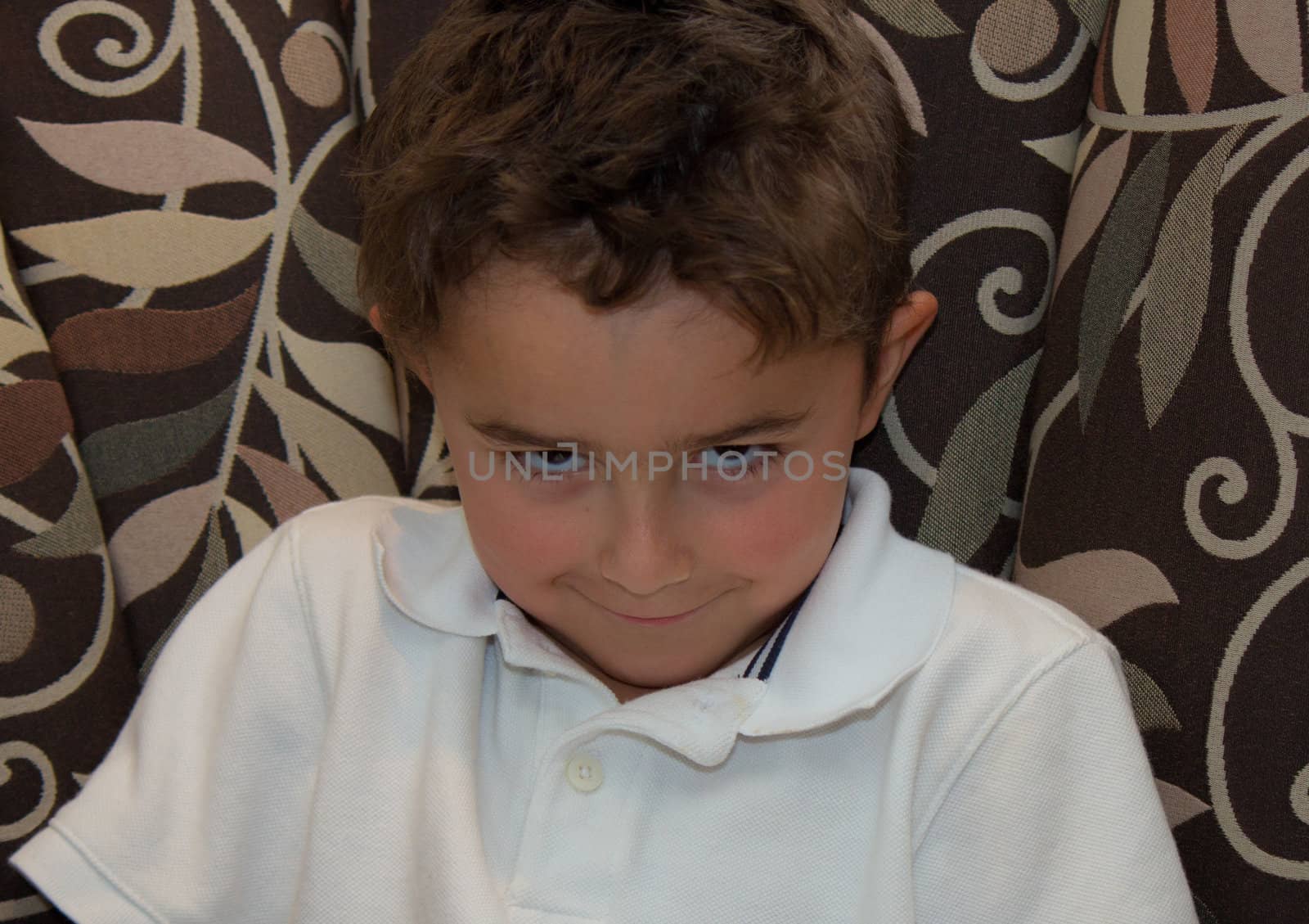 Child with sinister smirk posing.