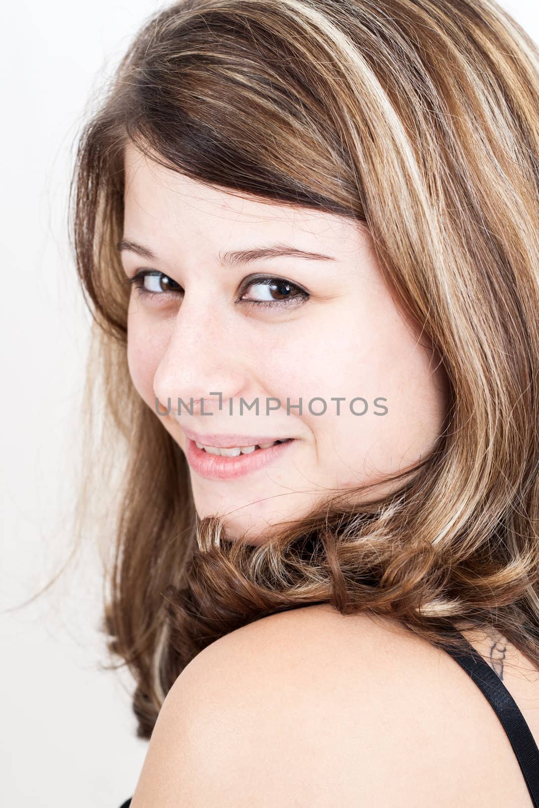 Portrait of a young brunette girl with brown eyes