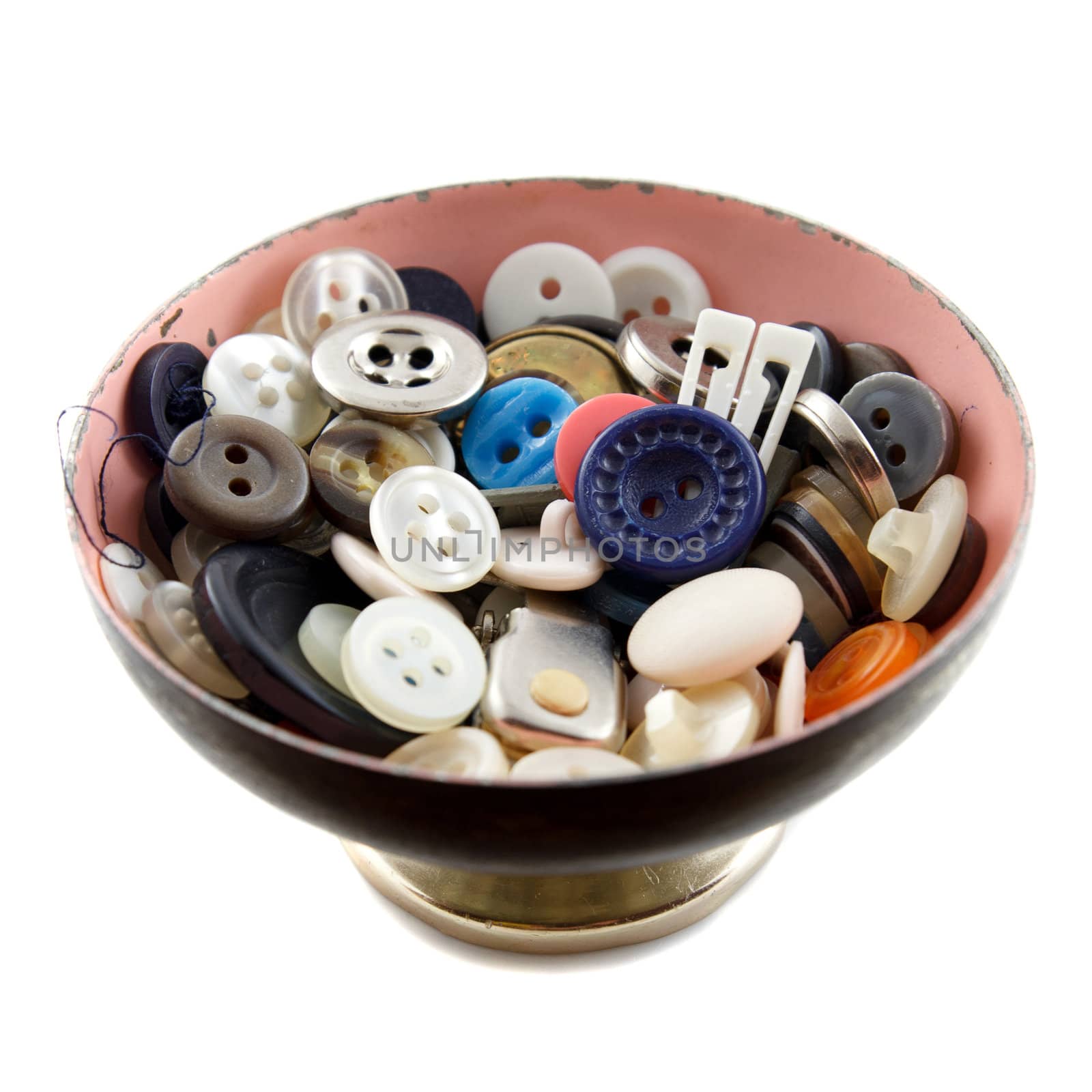 A bowl with buttons and other sewing accessories on a white background