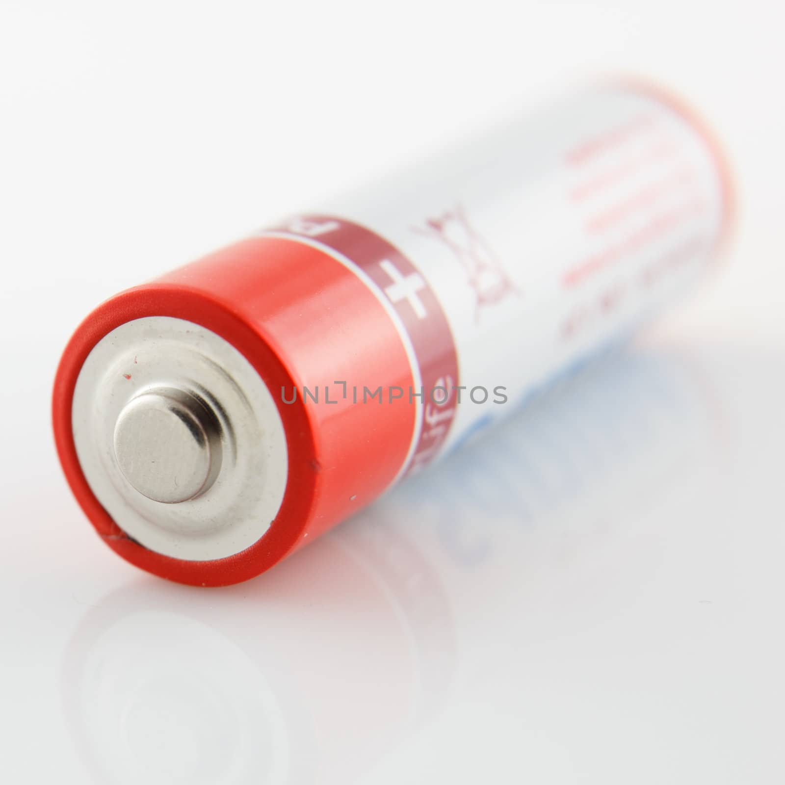 studio photography of a classic battery whit red stripes