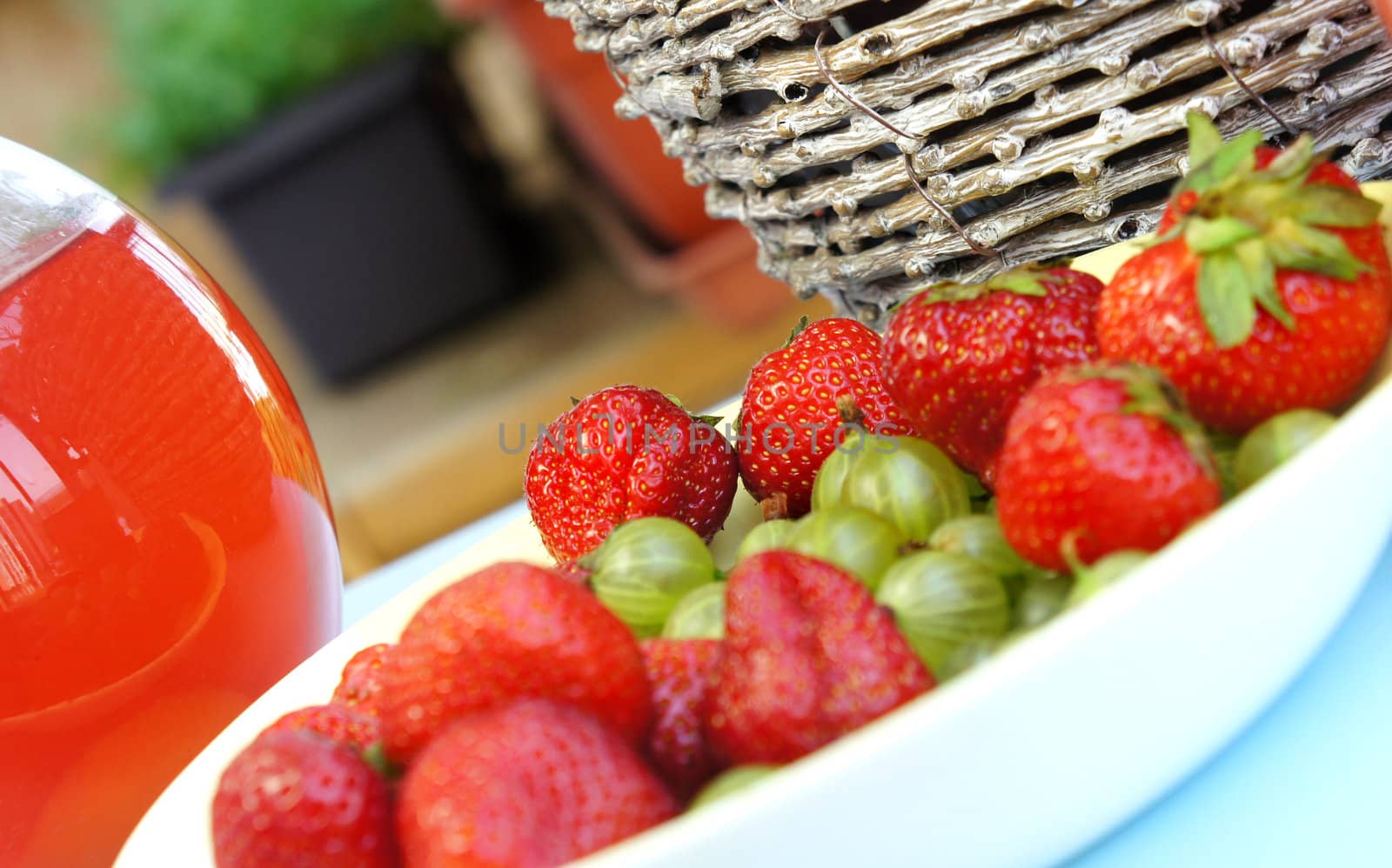 Strawberries, gooseberry, basket and fresh fruit compote        