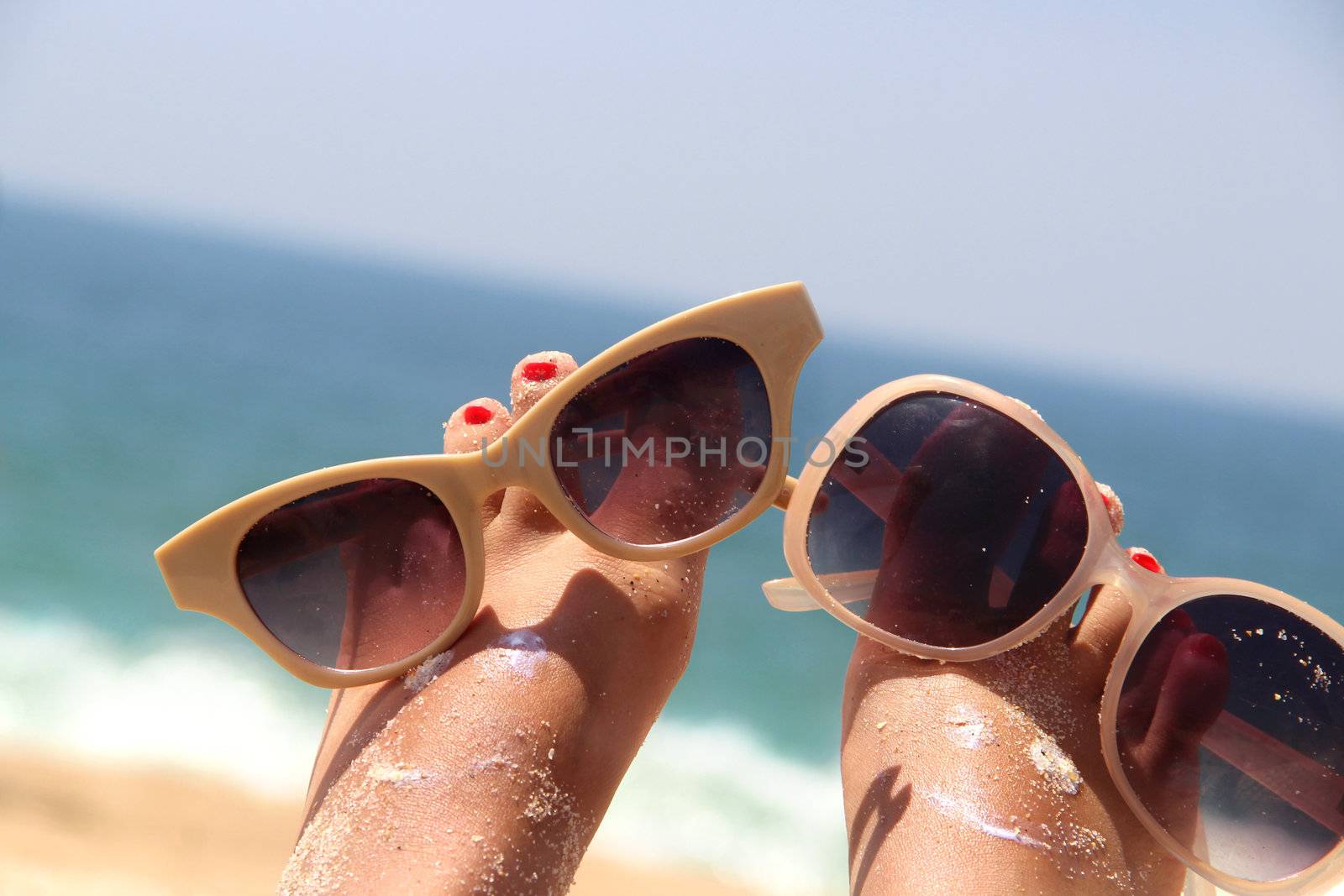 Summer holiday - funny female feet in sunglasses
