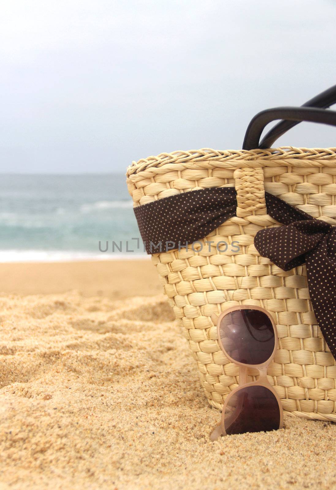 Sea time - seacoast, straw beach bag and sunglasses