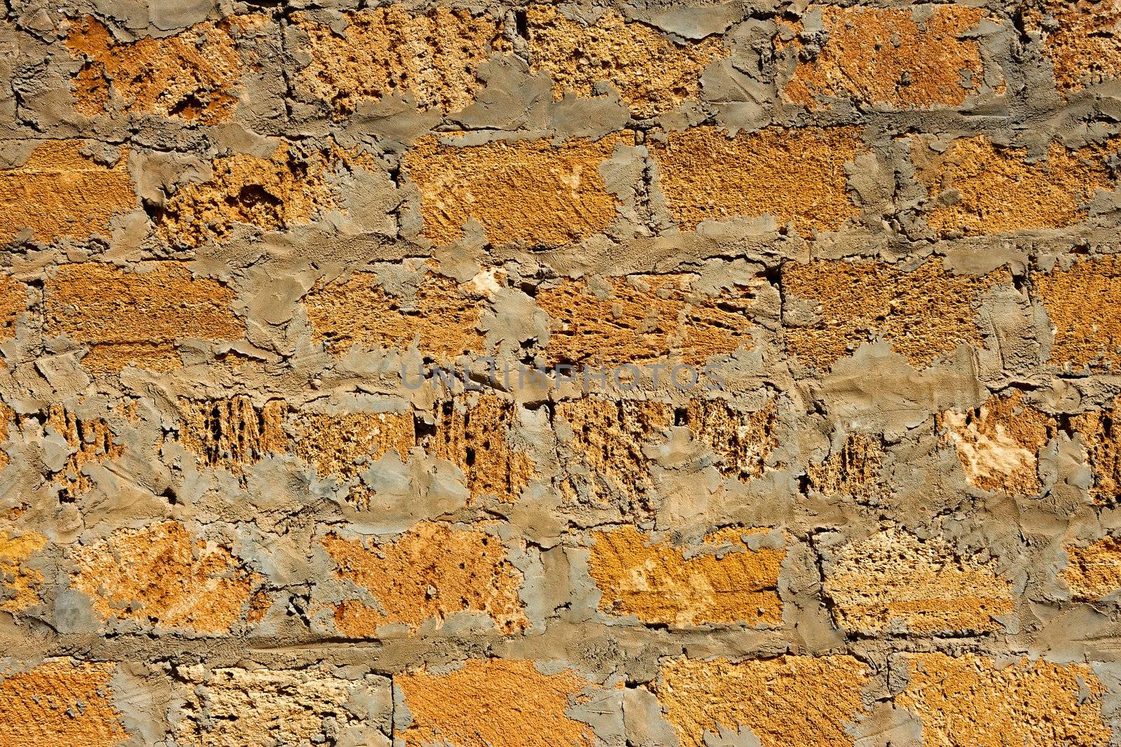 Fragment of a wall of limestone blocks sealed with cement mortar