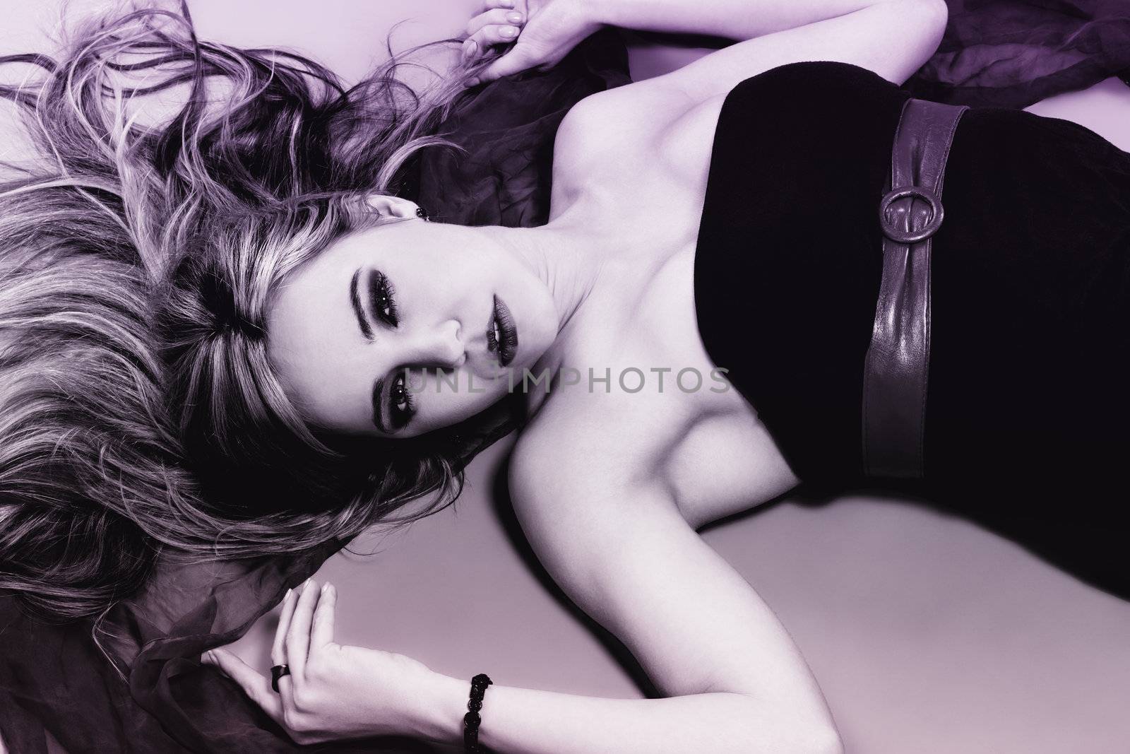 beautiful woman from top on the floor in purple black colors