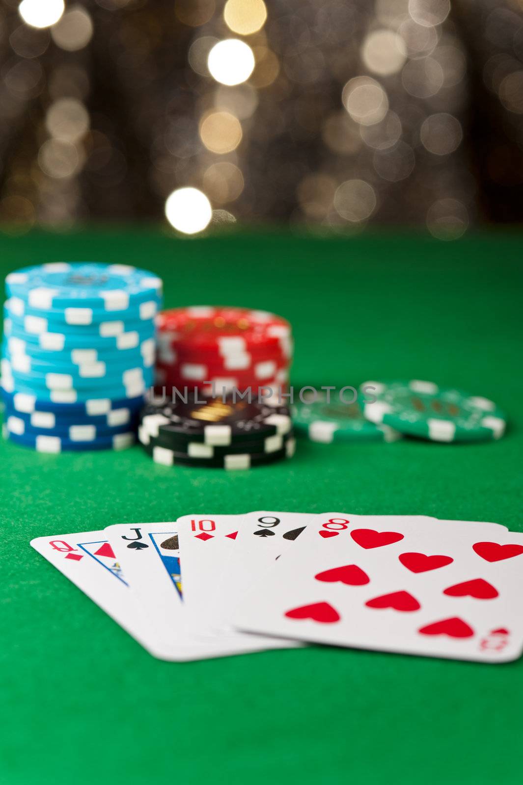 Straight flush, with chips in front of a gold glitter background