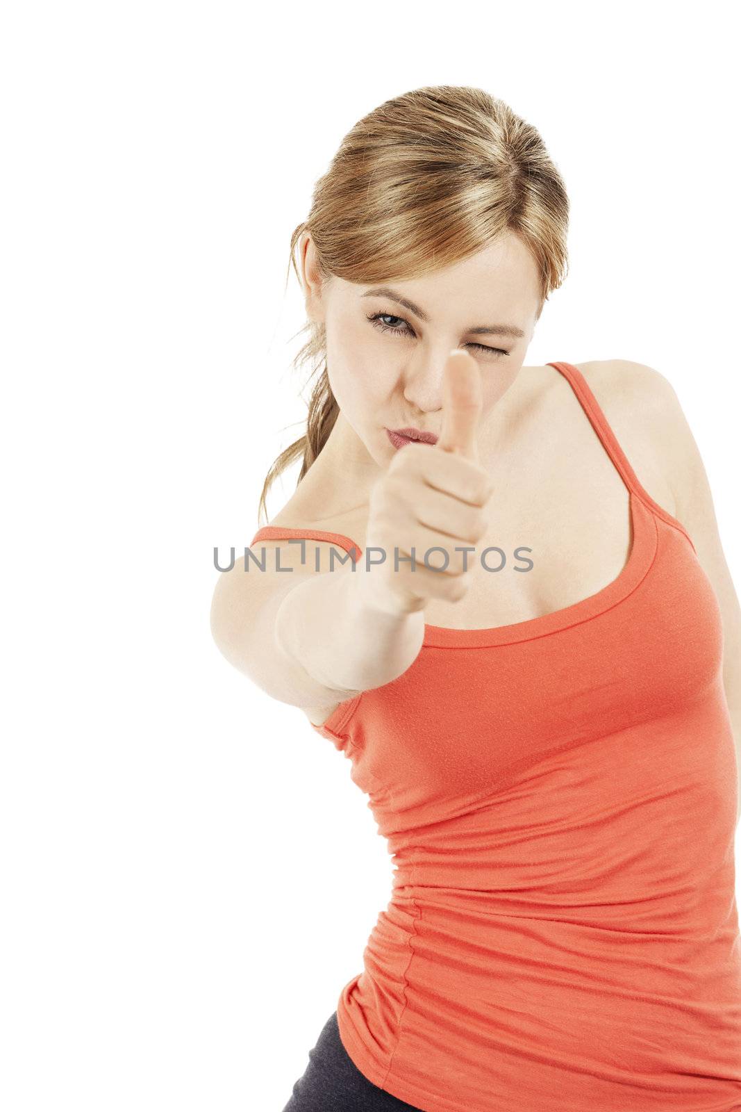 beautiful blonde fitness woman aiming with her thumb on white background