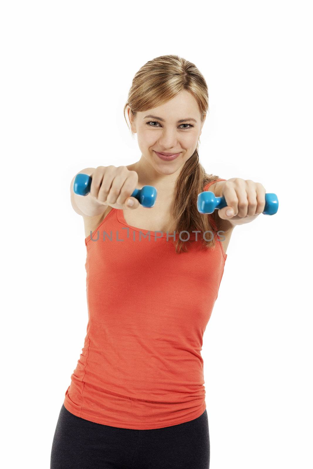 smiling cute fitness woman exercising with blue dumbbells on white background