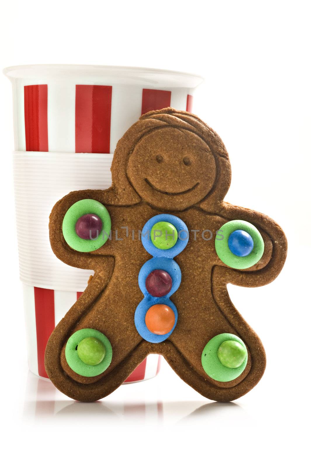 Red and white coffee mug with colorful gingerbread man