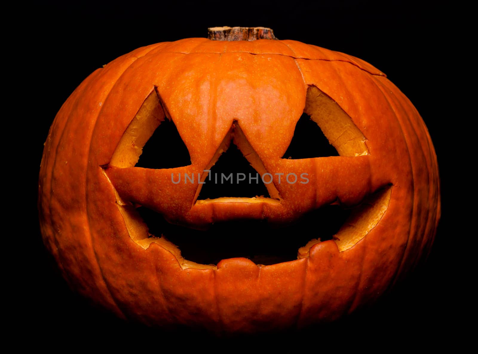 A scary Halloween pumpkin on black
