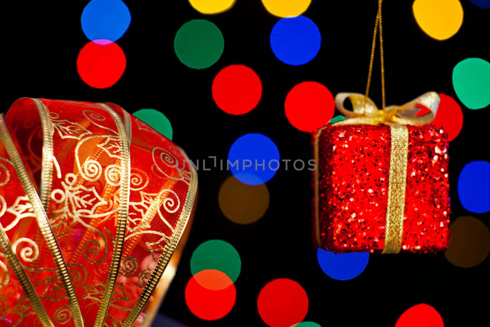 Red ribbon and gift with sereval colors light