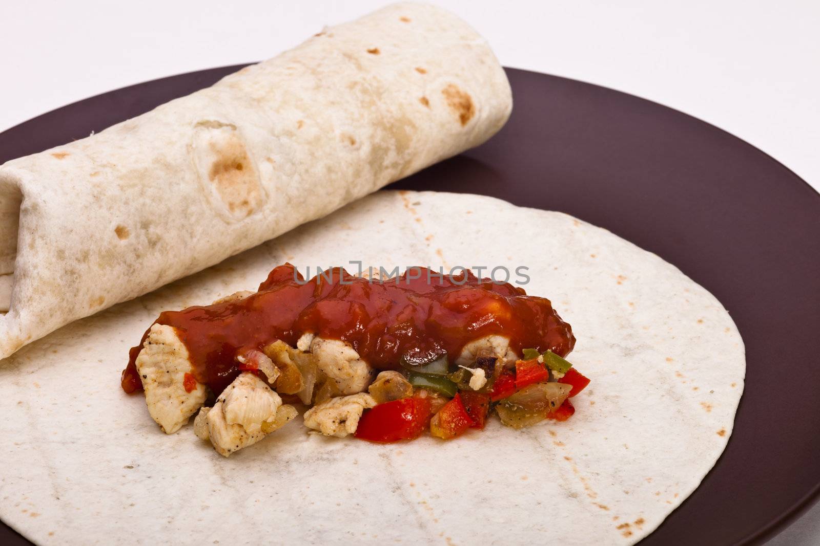Burritos with chicken pepper onion garlic and sauce