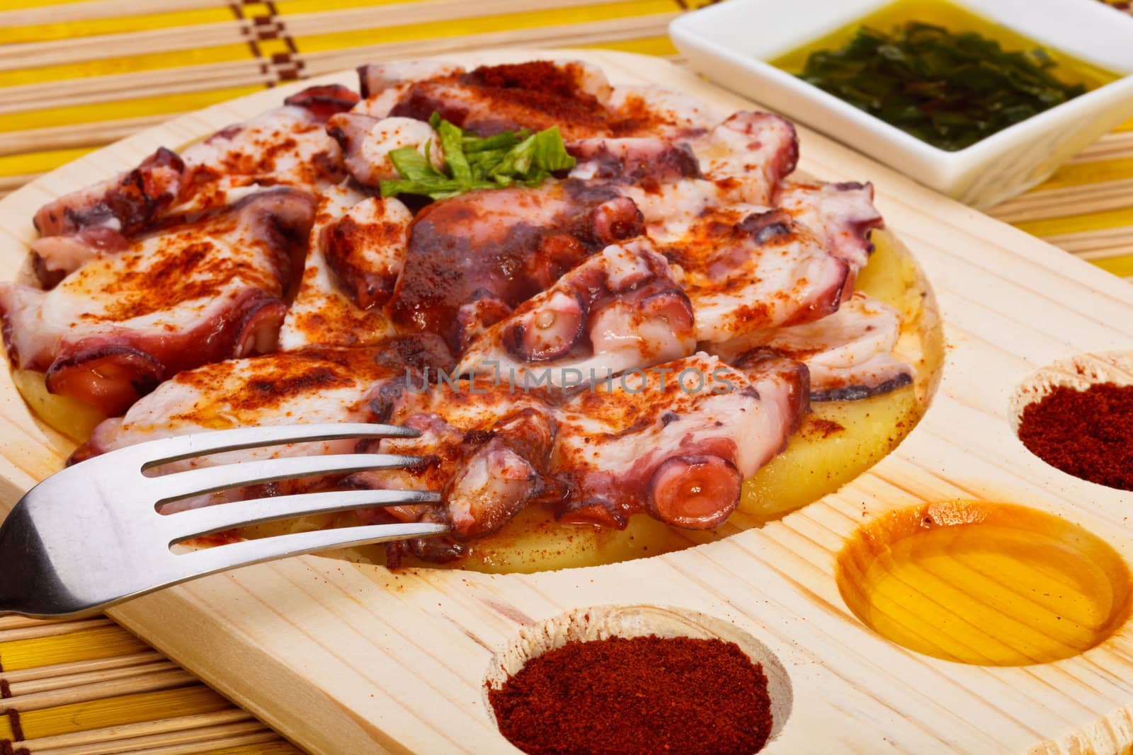 Octopus with paprika, potatoes and olive oil typical of Galicia, Spain